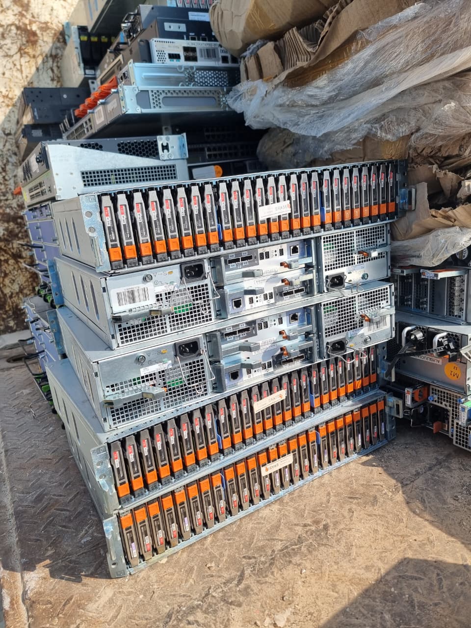 Stacked enterprise storage arrays and servers collected for IT scrap recycling